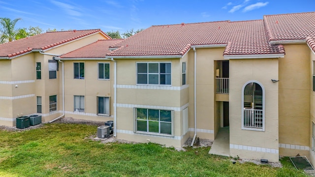 595 Vista Isles Dr Unit 1926, Sunrise, FL 33325 - rear view of house with central AC unit, stucco siding, and a tile roof
