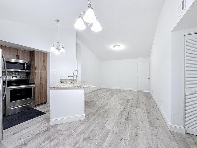 595 Vista Isles Dr Unit 1926, Sunrise, FL 33325 - kitchen with stainless steel appliances, vaulted ceiling, a chandelier, a sink, and light wood finished floors
