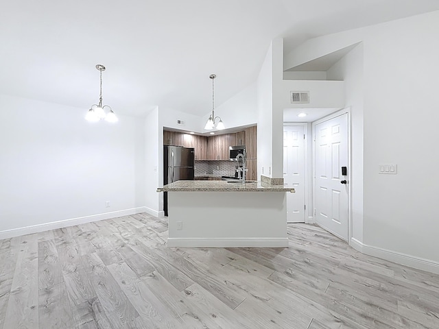 595 Vista Isles Dr Unit 1926, Sunrise, FL 33325 - kitchen with stainless steel appliances, light wood finished floors, a chandelier, baseboards, and high vaulted ceiling