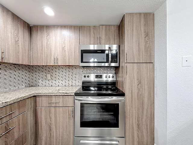 595 Vista Isles Dr Unit 1926, Sunrise, FL 33325 - kitchen with appliances with stainless steel finishes, tasteful backsplash, modern cabinets, light stone countertops, and light brown cabinets