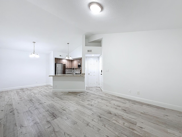 595 Vista Isles Dr Unit 1926, Sunrise, FL 33325 - unfurnished living room featuring a chandelier, light wood-style flooring, baseboards, and high vaulted ceiling