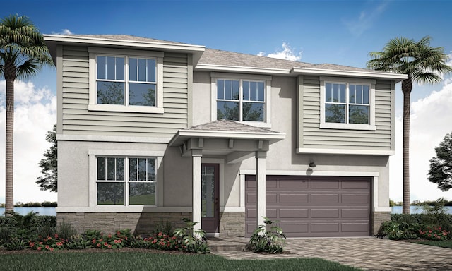 traditional home featuring a garage, stone siding, decorative driveway, and stucco siding
