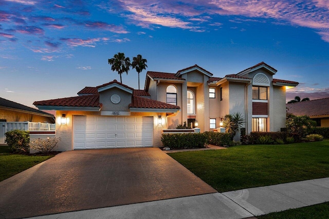 11217 Island Lakes Ln, Boca Raton, FL 33498 - view of front facade with an attached garage, stucco siding, driveway, a lawn, and a tile roof