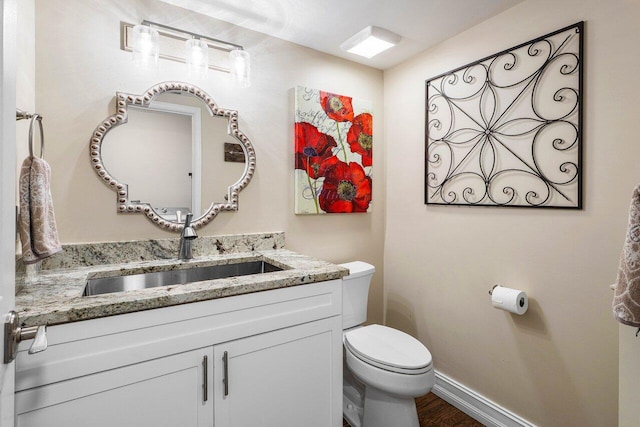 11217 Island Lakes Ln, Boca Raton, FL 33498 - half bath featuring toilet, vanity, baseboards, and wood finished floors