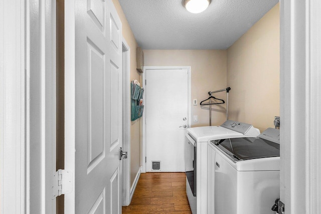 11217 Island Lakes Ln, Boca Raton, FL 33498 - washroom with separate washer and dryer, dark wood-style floors, and a textured ceiling