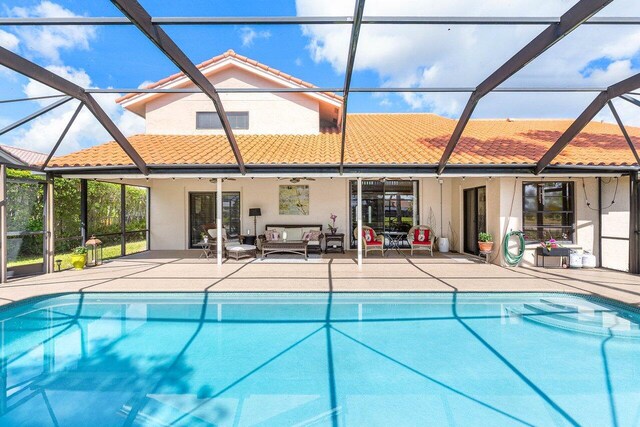 11217 Island Lakes Ln, Boca Raton, FL 33498 - outdoor pool with glass enclosure, a patio, and an outdoor hangout area