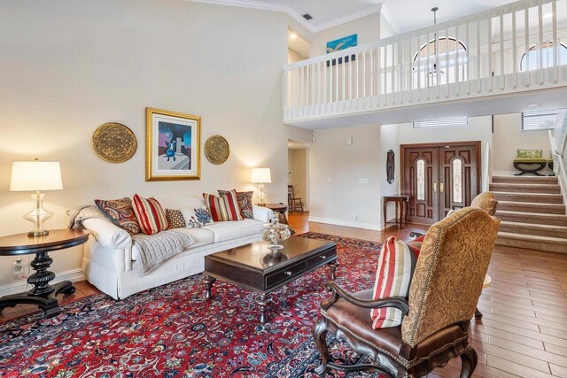 11217 Island Lakes Ln, Boca Raton, FL 33498 - living area featuring stairs, wood finished floors, baseboards, crown molding, and a high ceiling
