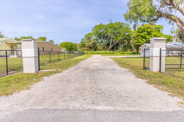 2675 SW 24th Ave, Okeechobee, FL 34974 - view of dirt / gravel driveway featuring a gated entry