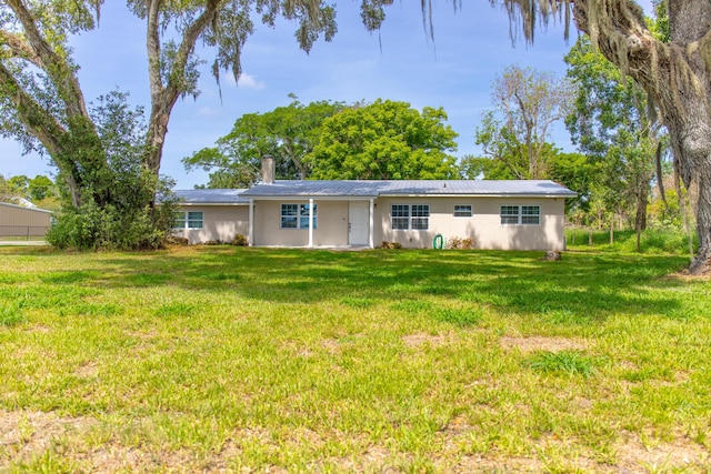 2675 SW 24th Ave, Okeechobee, FL 34974 - view of front facade featuring a front yard, metal roof, and stucco siding