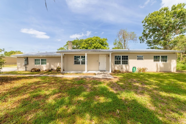 2675 SW 24th Ave, Okeechobee, FL 34974 - single story home with a front yard, a chimney, stucco siding, and metal roof