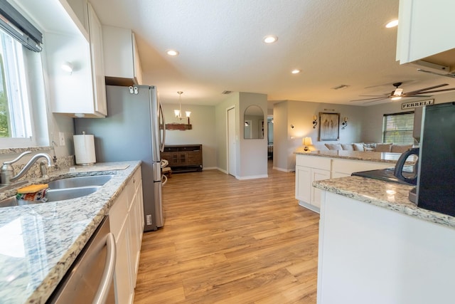 2675 SW 24th Ave, Okeechobee, FL 34974 - kitchen featuring a sink, white cabinets, light wood-style floors, a ceiling fan, and recessed lighting