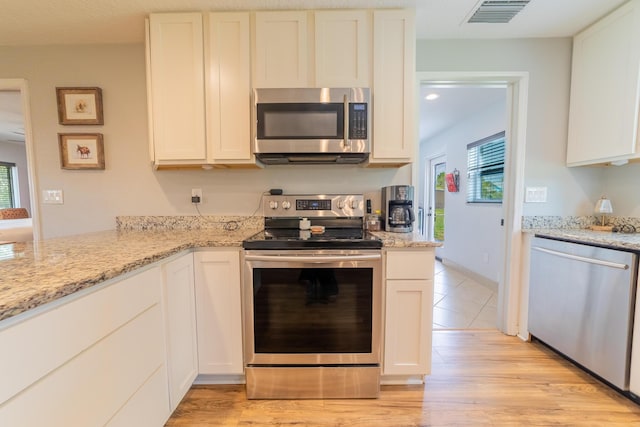 2675 SW 24th Ave, Okeechobee, FL 34974 - kitchen with appliances with stainless steel finishes and white cabinetry