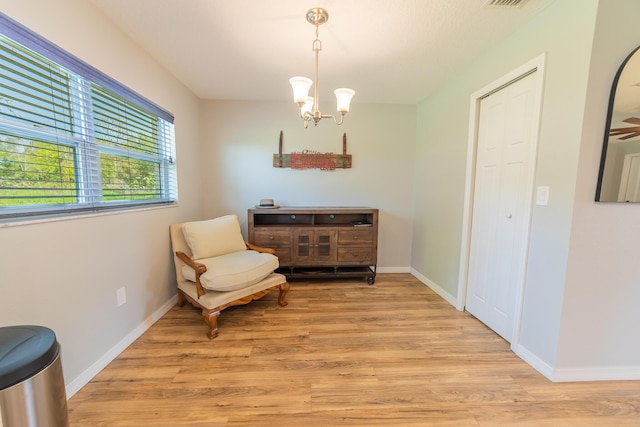 2675 SW 24th Ave, Okeechobee, FL 34974 - sitting room featuring light wood-style floors, a chandelier, and baseboards
