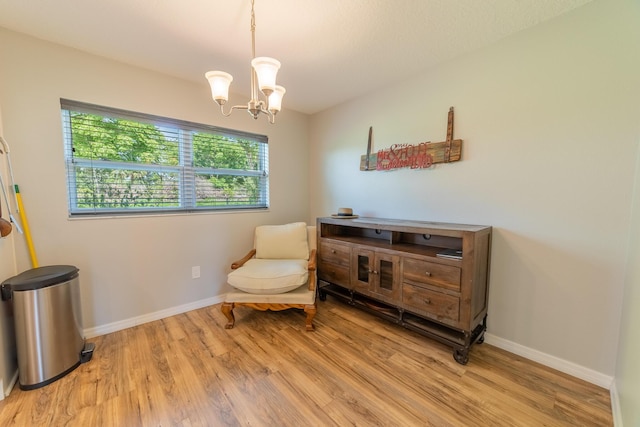 2675 SW 24th Ave, Okeechobee, FL 34974 - living area with light wood finished floors, a chandelier, and baseboards