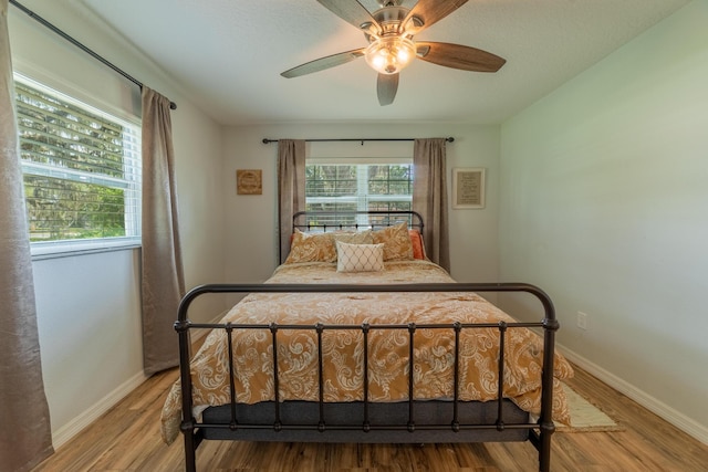 2675 SW 24th Ave, Okeechobee, FL 34974 - bedroom with baseboards, wood finished floors, and ceiling fan