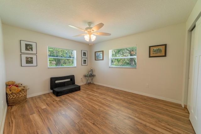 2675 SW 24th Ave, Okeechobee, FL 34974 - sitting room featuring wood finished floors, a ceiling fan, a textured ceiling, and baseboards