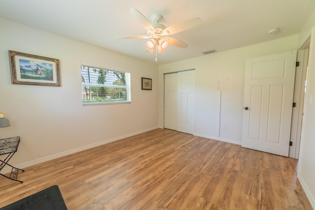 2675 SW 24th Ave, Okeechobee, FL 34974 - unfurnished bedroom with light wood-style floors, a closet, baseboards, and a ceiling fan