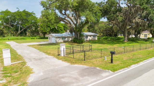 2675 SW 24th Ave, Okeechobee, FL 34974 - ranch-style house featuring asphalt driveway, an attached garage, and view of scattered trees