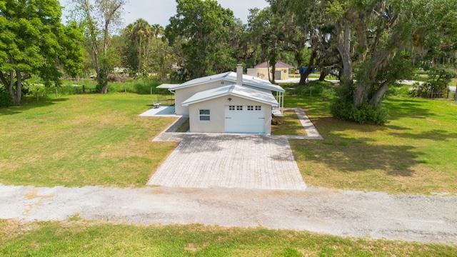 2675 SW 24th Ave, Okeechobee, FL 34974 - view of front of house with a garage, stucco siding, driveway, and a front yard