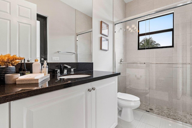 full bath featuring vanity, tile patterned floors, toilet, and a shower stall