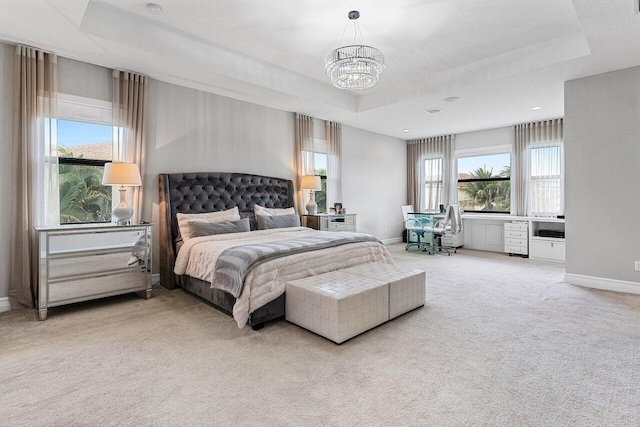 bedroom featuring baseboards, carpet, a chandelier, and a tray ceiling