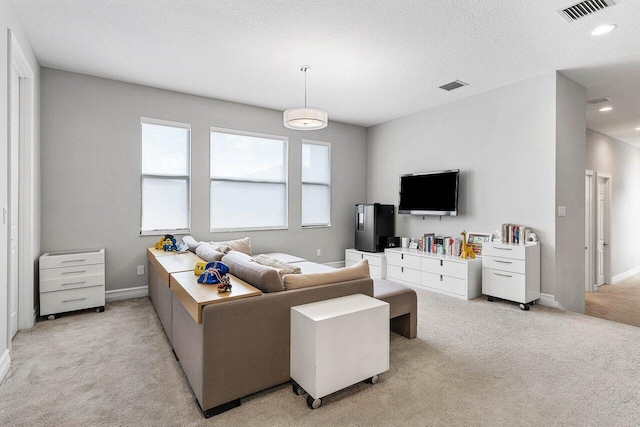 living room with visible vents, recessed lighting, baseboards, and light colored carpet