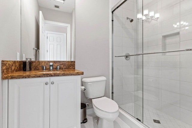 bathroom with toilet, visible vents, a shower stall, and vanity