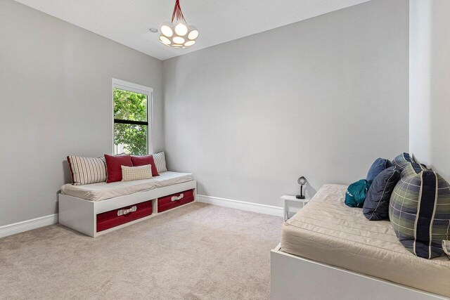 sitting room featuring carpet floors and baseboards