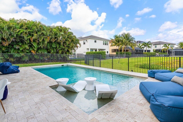 view of swimming pool featuring fence, a residential view, a fenced in pool, a patio area, and a lawn
