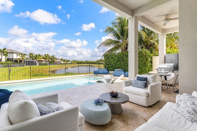 view of swimming pool with an outdoor living space, a fenced backyard, and ceiling fan