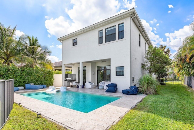 rear view of house featuring an outdoor hangout area, a fenced in pool, a fenced backyard, a lawn, and a patio