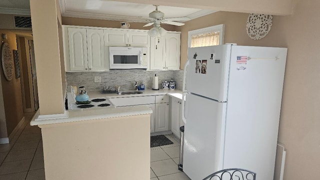 880 Horizons W Unit 112, Boynton Beach, FL 33435 - kitchen with light tile patterned floors, white appliances, tasteful backsplash, and a peninsula