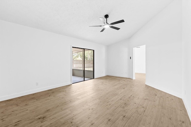 empty room featuring vaulted ceiling, a ceiling fan, light wood finished floors, and baseboards