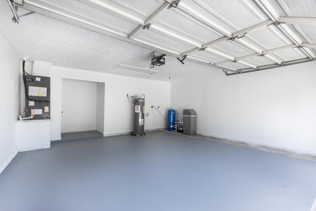 garage featuring heating unit, electric water heater, and a garage door opener
