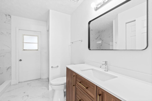 bathroom with marble finish floor, toilet, vanity, walk in shower, and a textured ceiling