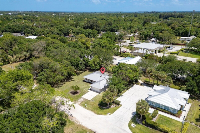 birds eye view of property with a view of trees