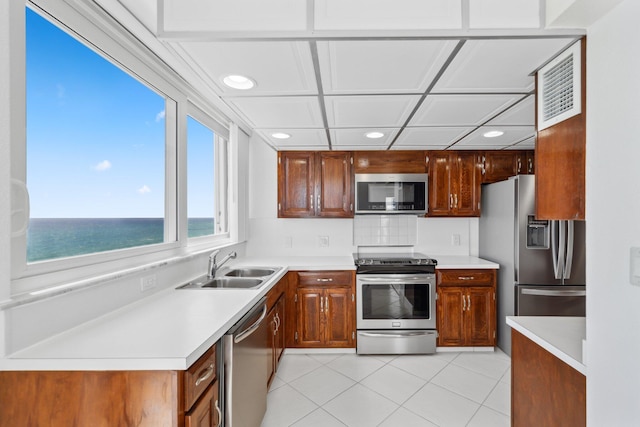 1370 S Ocean Blvd Unit 1808, Pompano Beach, FL 33062 - kitchen with appliances with stainless steel finishes, recessed lighting, light countertops, light tile patterned flooring, and a water view