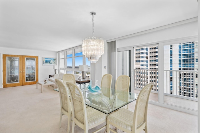 1370 S Ocean Blvd Unit 1808, Pompano Beach, FL 33062 - carpeted dining room featuring a chandelier and french doors