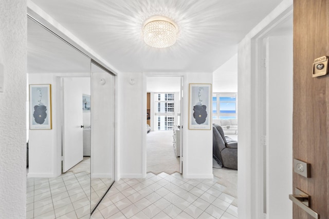 1370 S Ocean Blvd Unit 1808, Pompano Beach, FL 33062 - hallway featuring a chandelier and light carpet