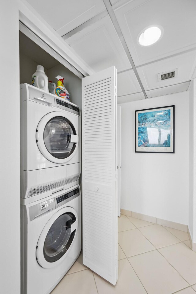 1370 S Ocean Blvd Unit 1808, Pompano Beach, FL 33062 - laundry room featuring stacked washer and clothes dryer and light tile patterned floors
