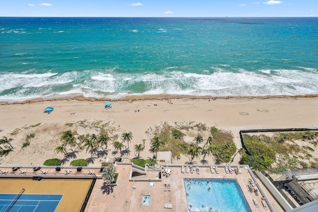 drone / aerial view of expansive coastline and a pool area