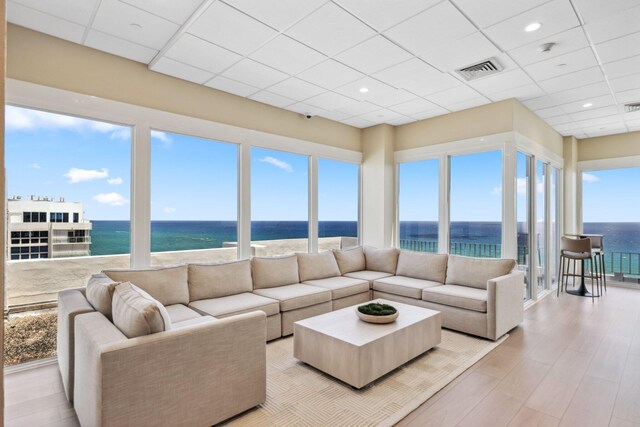 1370 S Ocean Blvd Unit 1808, Pompano Beach, FL 33062 - living area with a drop ceiling, light wood-style flooring, and a water view