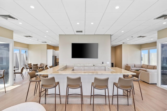 1370 S Ocean Blvd Unit 1808, Pompano Beach, FL 33062 - bar with light wood-style flooring, plenty of natural light, recessed lighting, and freestanding refrigerator