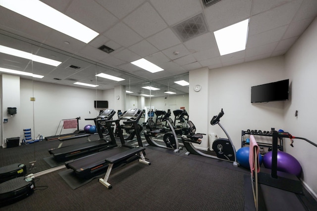 exercise room with a paneled ceiling