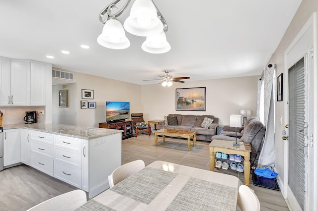 kitchen featuring a ceiling fan, a peninsula, white cabinetry, visible vents, and recessed lighting