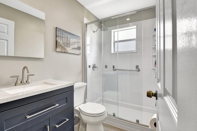 full bathroom with a shower stall, toilet, and vanity