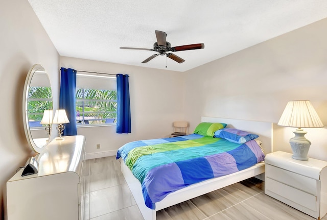 bedroom featuring baseboards and ceiling fan