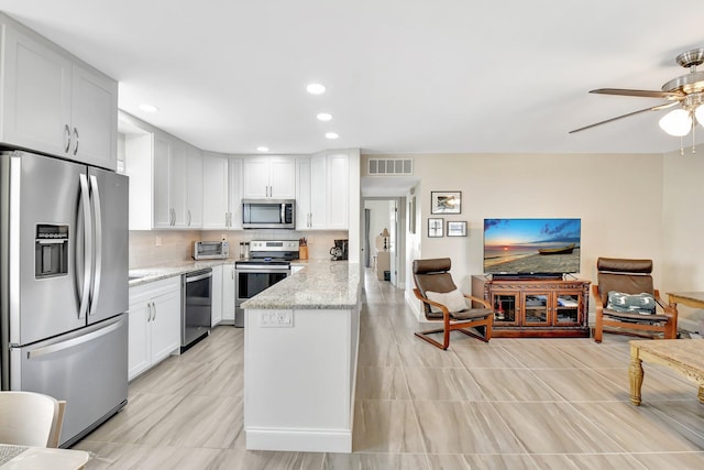 kitchen featuring ceiling fan, visible vents, light stone countertops, appliances with stainless steel finishes, and white cabinetry