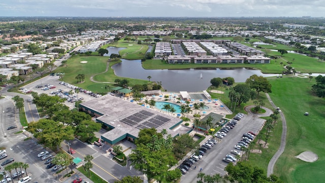 drone / aerial view with a water view and golf course view