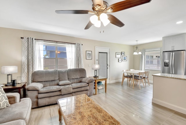 living area featuring light tile patterned floors, baseboards, recessed lighting, and ceiling fan